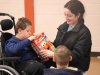Child at Saturday Kids Club at Stepping Stones Ohio opens gift with counselor