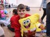 Child at Saturday Kids Club, part of Stepping Stones Ohio opens his holiday gift