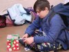 Child at Saturday Kids Club at Stepping Stones Ohio opens holiday gift