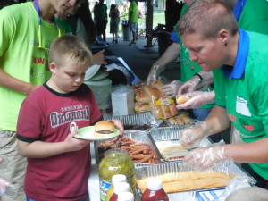 Participants grab picnic food - hamburgers or hot dogs!