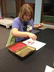 Emily decorates her corn mosaic!