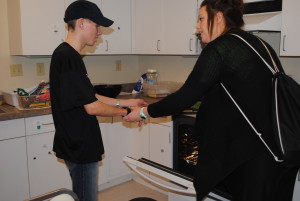 Hilary helps Zach put cookies into the oven! 
