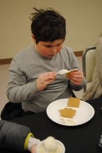 Luke working hard on forming his gingerbread house! 